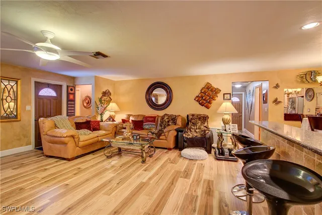 a kitchen with stainless steel appliances granite countertop a refrigerator a stove and a wooden floors