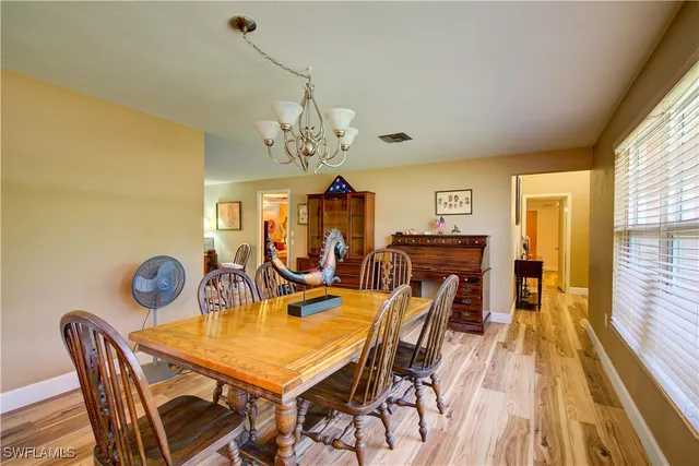 a bedroom with a bed and a large mirror on the dresser