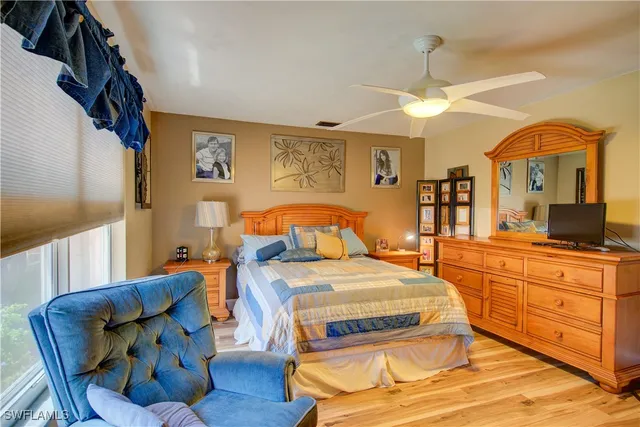 a bedroom with a bed and wooden floor