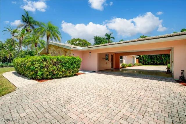 a front view of a house with a yard and a garage