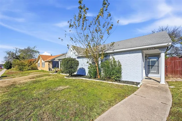 a view of a house with a big yard and potted plants