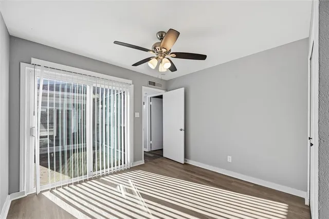 a view of a bedroom with wooden floor