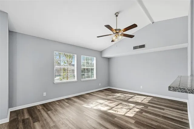 a view of a room with window and ceiling fan