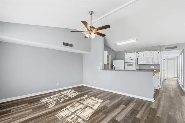 a view of a kitchen with a stove and cabinets