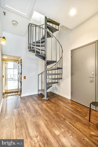 a view of a room with wooden floor and windows