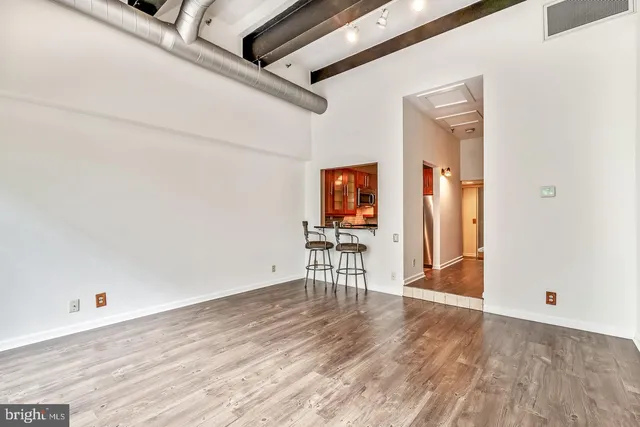 an empty room with wooden floor and furniture