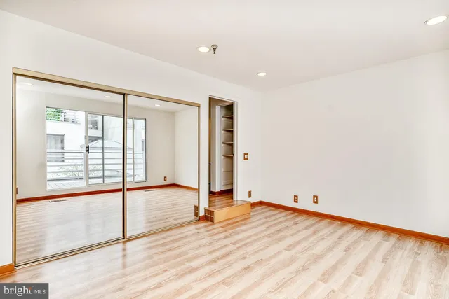 a bathroom with a sink a toilet a mirror a vanity and shower