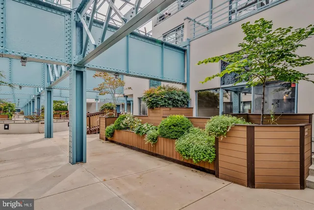 a view of a balcony with wooden floor and iron stairs