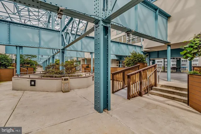 a dining hall with stainless steel appliances kitchen island granite countertop a table and chairs in it