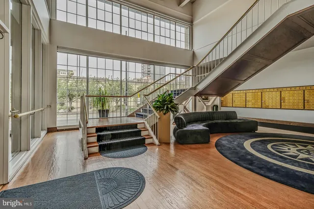 a living room with furniture and flowers