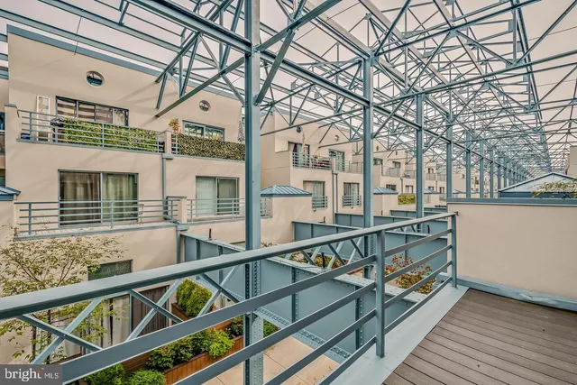 a view of an empty room with stairs and a window