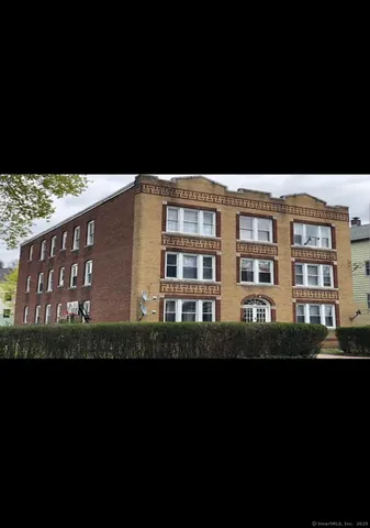 a black and white wall with building in background