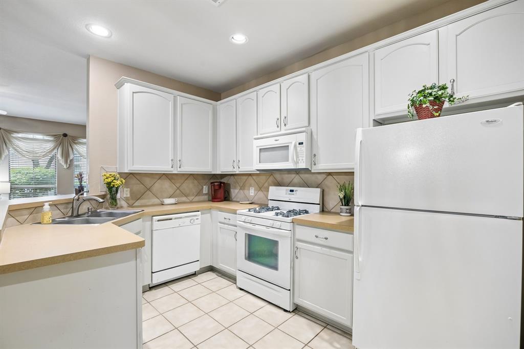 2003 Downing Street Allen, TX 75013 - Photo 14 of 40 Wow! Check out all the storage, stylish white appliances and SS sink with lovely backsplash!