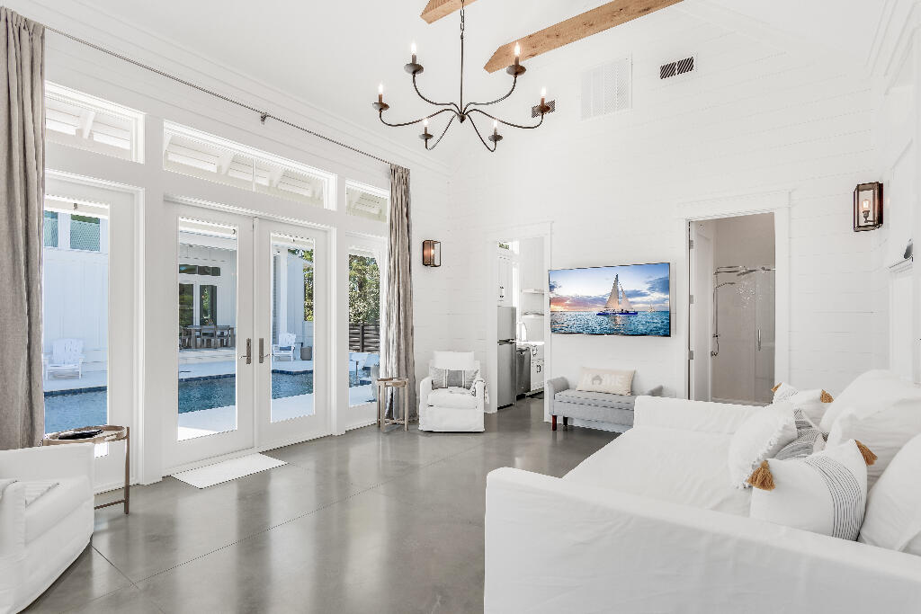 90 Sandstone Street Santa Rosa Beach, FL 32459 - Photo 17 of 73 a living room with furniture a large window and a chandelier