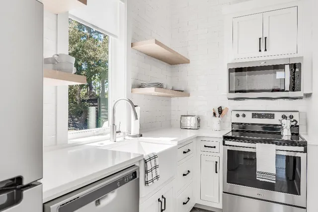 a bedroom with a bed a desk and chair next to a window