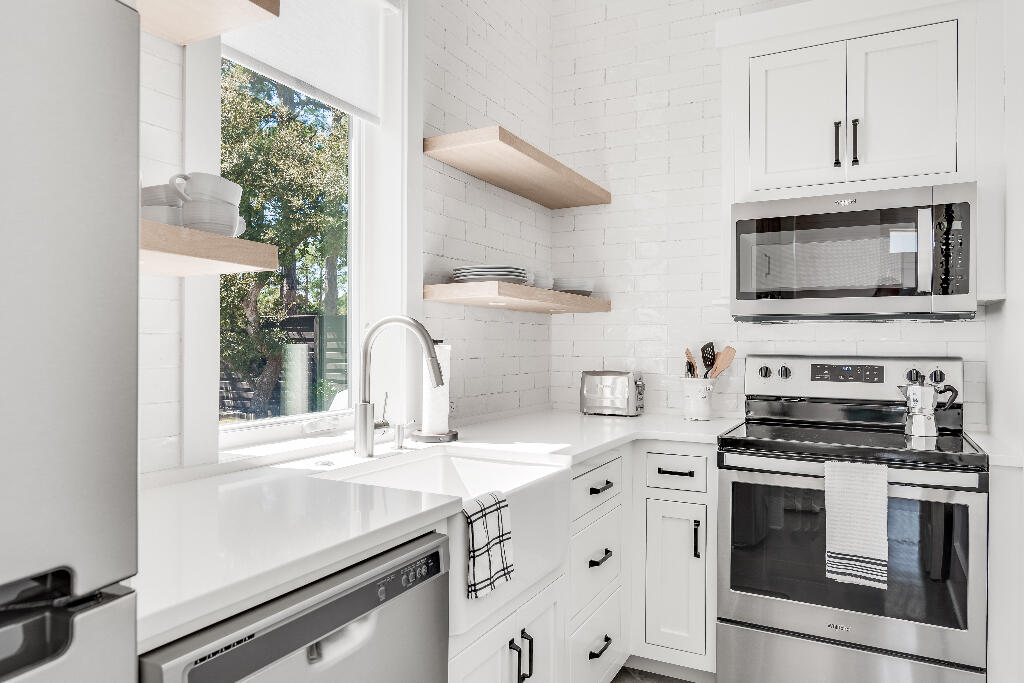 90 Sandstone Street Santa Rosa Beach, FL 32459 - Photo 19 of 73 a kitchen with stainless steel appliances a stove microwave and sink