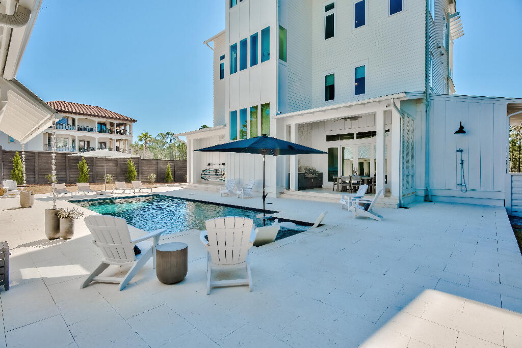 90 Sandstone Street Santa Rosa Beach, FL 32459 - Photo 22 of 73 a view of a patio with table and chairs and potted plants