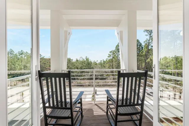 a living room with lots of furniture and a large window