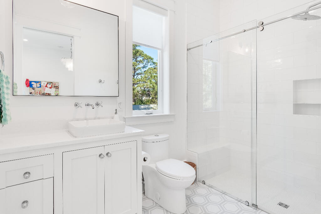 90 Sandstone Street Santa Rosa Beach, FL 32459 - Photo 38 of 73 a bathroom with a sink a toilet and a mirror