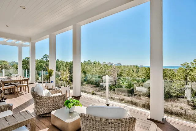 a view of empty room with wooden floor and floor to ceiling window