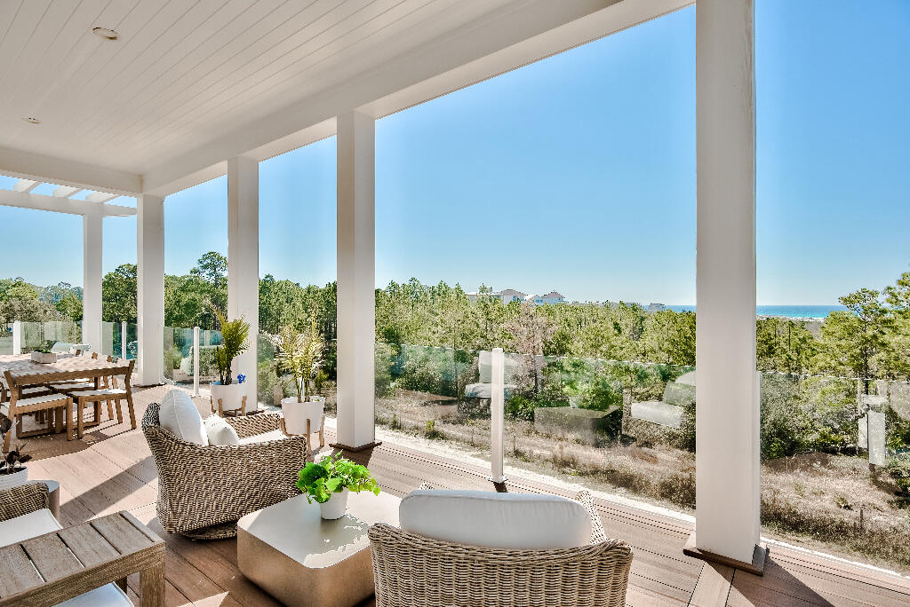 90 Sandstone Street Santa Rosa Beach, FL 32459 - Photo 47 of 73 a living room with furniture and a floor to ceiling window