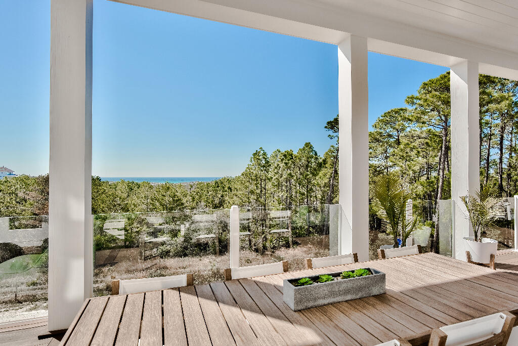 90 Sandstone Street Santa Rosa Beach, FL 32459 - Photo 48 of 73 a view of a balcony with floor to ceiling windows with wooden floor