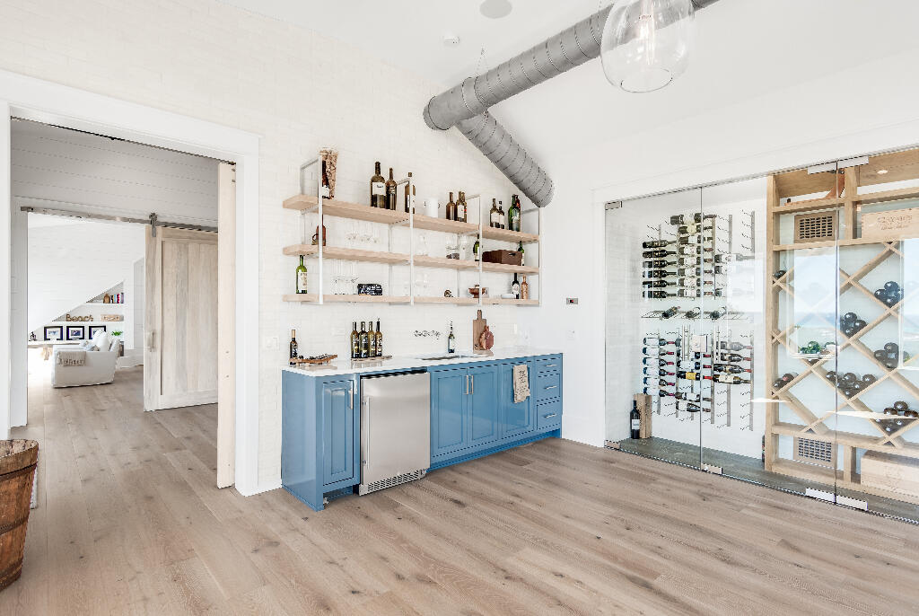 90 Sandstone Street Santa Rosa Beach, FL 32459 - Photo 62 of 73 a kitchen with stainless steel appliances a stove a sink and a refrigerator with wooden floor