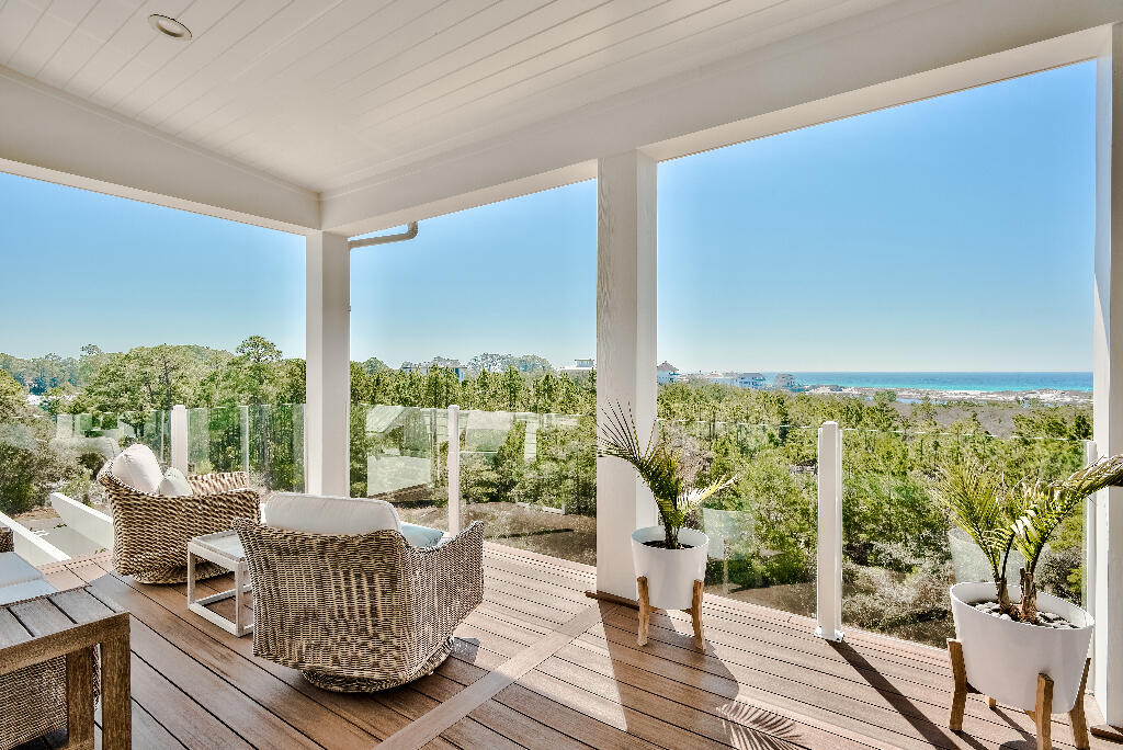 90 Sandstone Street Santa Rosa Beach, FL 32459 - Photo 69 of 73 a living room with furniture and a floor to ceiling window