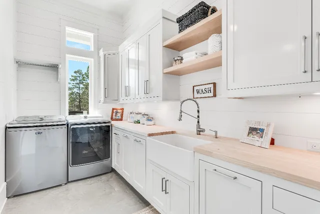 a living room with furniture a large window and a chandelier