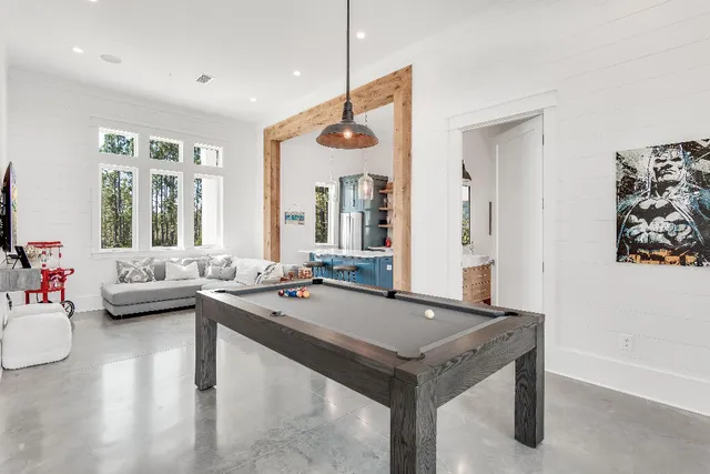 a living room with furniture and large windows