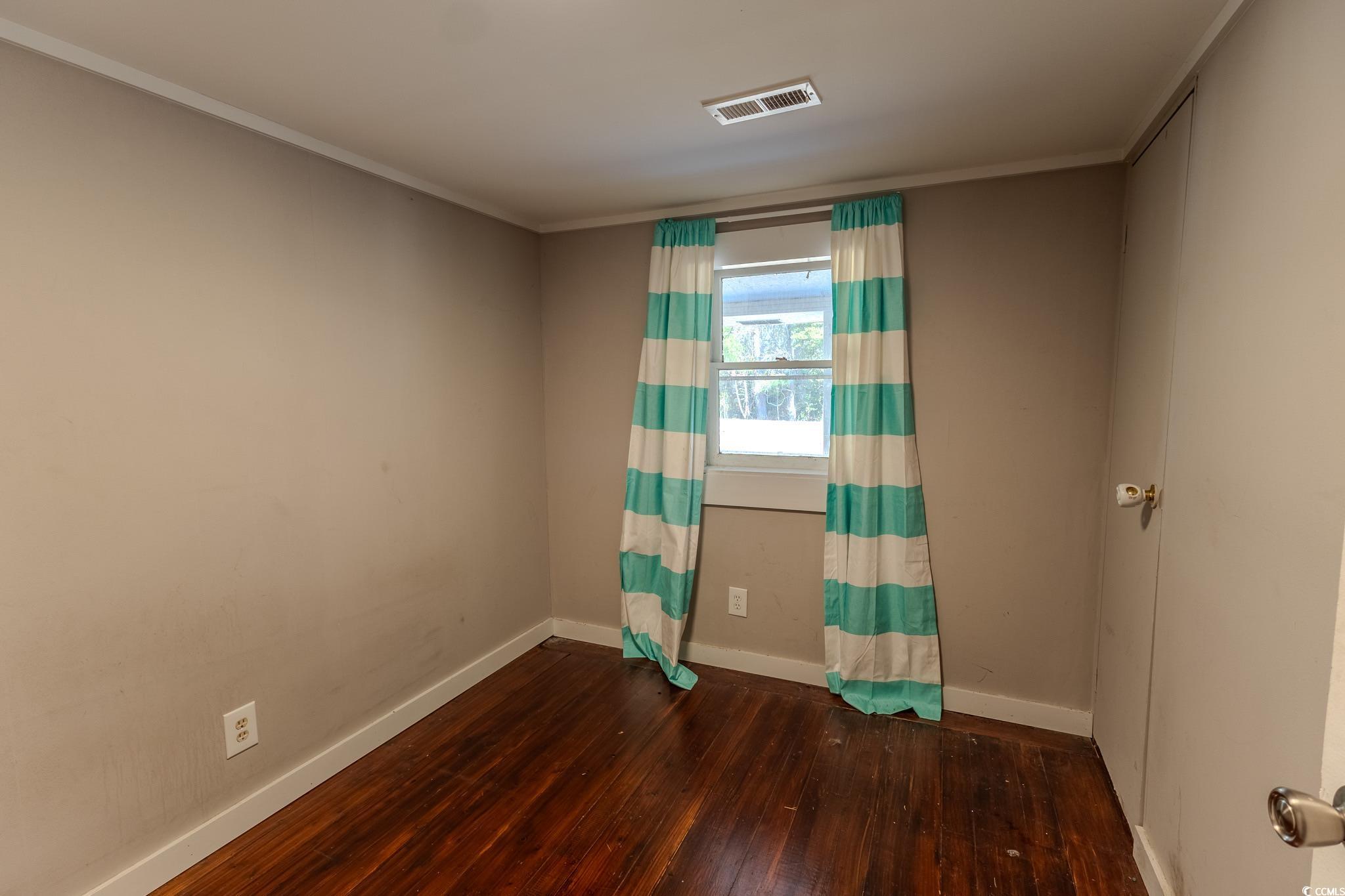 7755 Hunting Swamp Road Conway, SC 29527 - Photo 15 of 19 Exercise room featuring dark wood-type flooring and ornamental molding