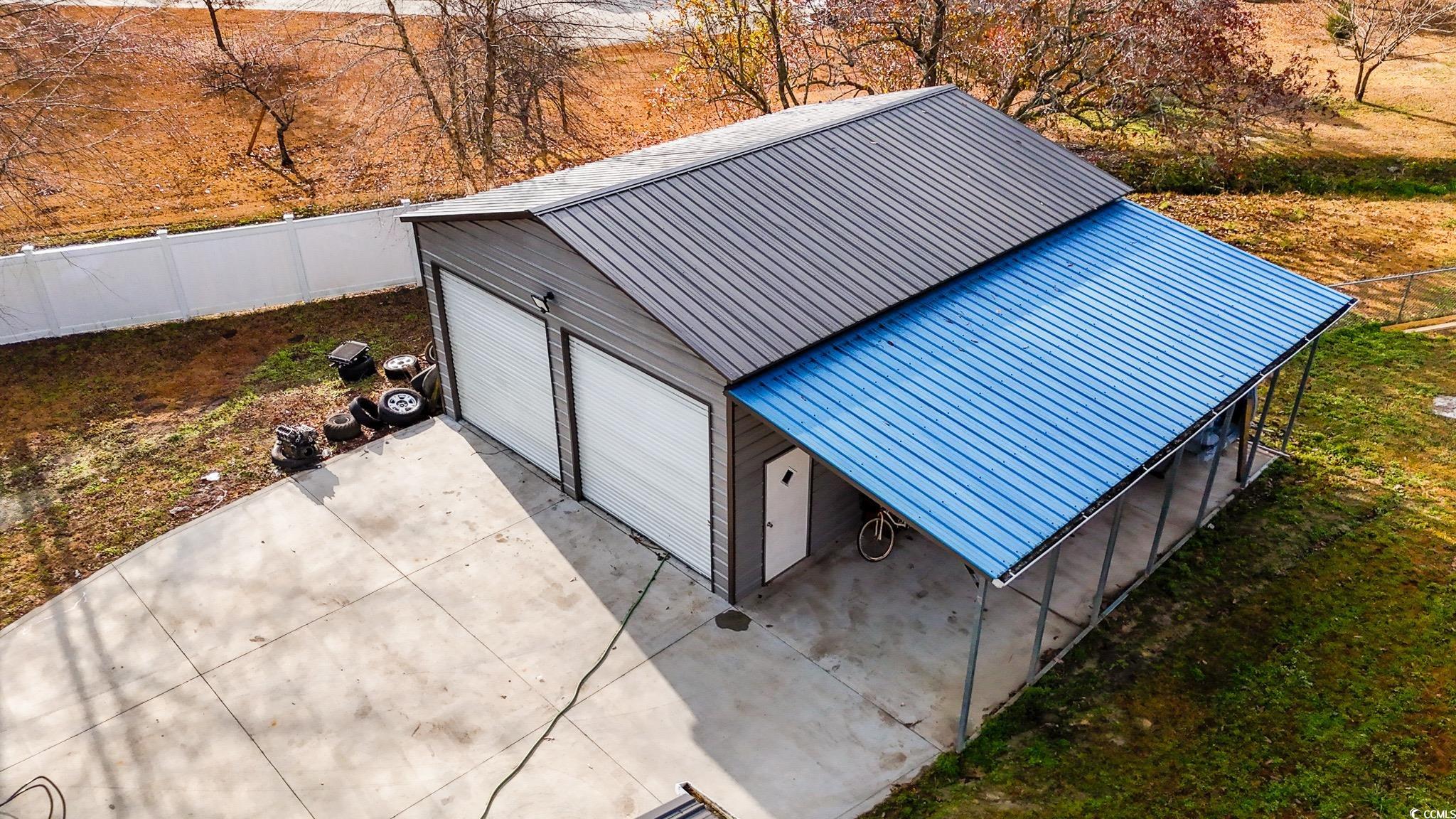 7755 Hunting Swamp Road Conway, SC 29527 - Photo 18 of 19 Unfurnished living room with a wood stove, a ceiling fan, and light wood-style flooring