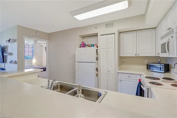 a kitchen with a sink cabinets and appliances