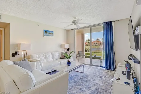 a living room with furniture and a floor to ceiling window
