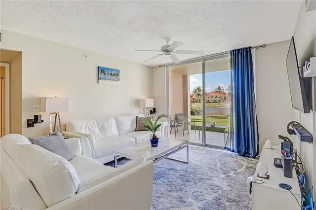 a living room with furniture and a floor to ceiling window