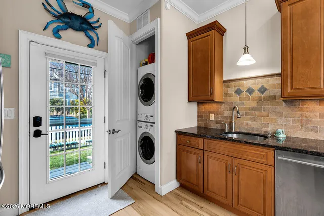 a kitchen with stainless steel appliances granite countertop a sink a stove and a wooden floors