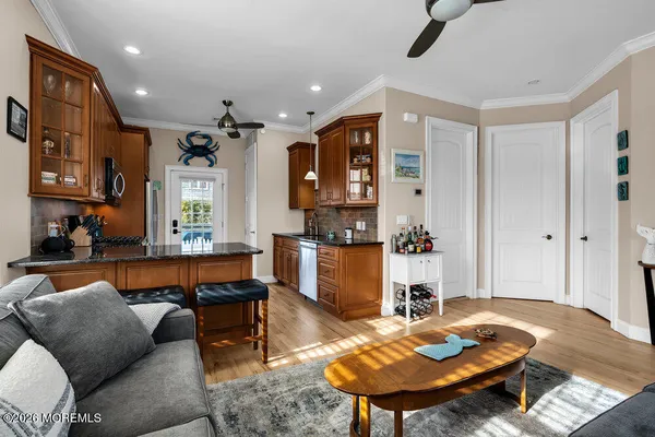 a kitchen with granite countertop wooden cabinets a stove top oven and stainless steel appliances