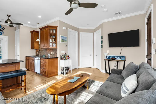 a kitchen with granite countertop a stove top oven a sink dishwasher and cabinets with wooden floor