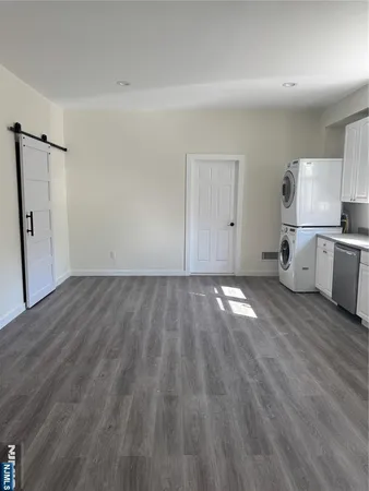 an empty room with wooden floor and closet