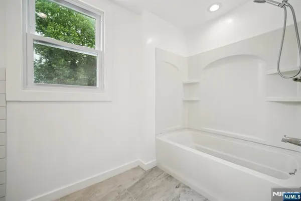 a white bath tub sitting next to a window