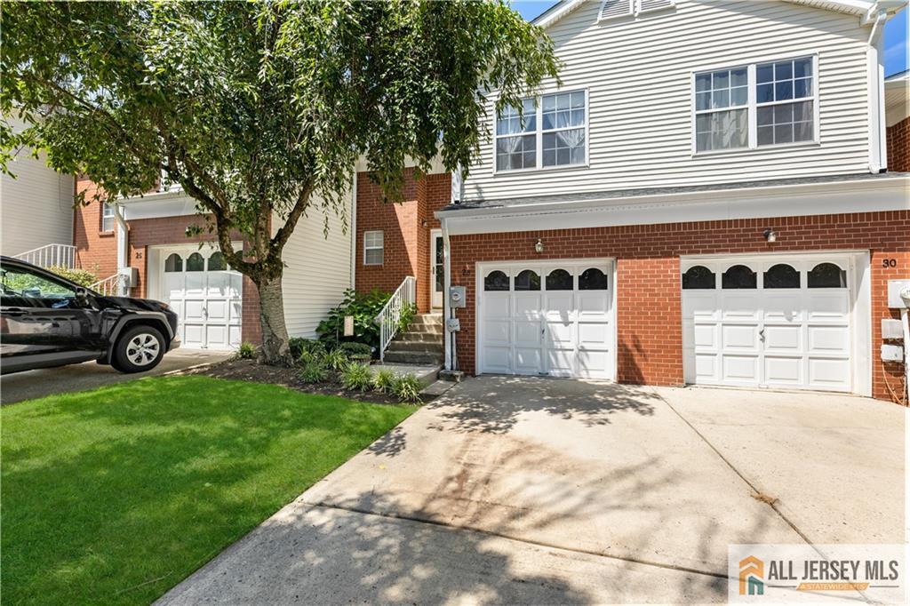 28 Garfield Way Princeton, NJ 08540 - Photo 2 of 39 a front view of a house with a yard and garage