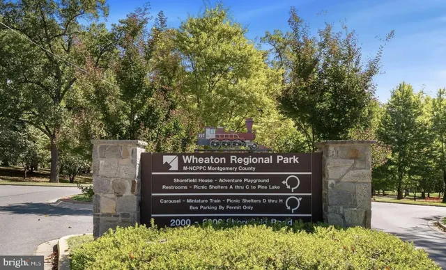 a view of a garden with a table and chairs under an umbrella