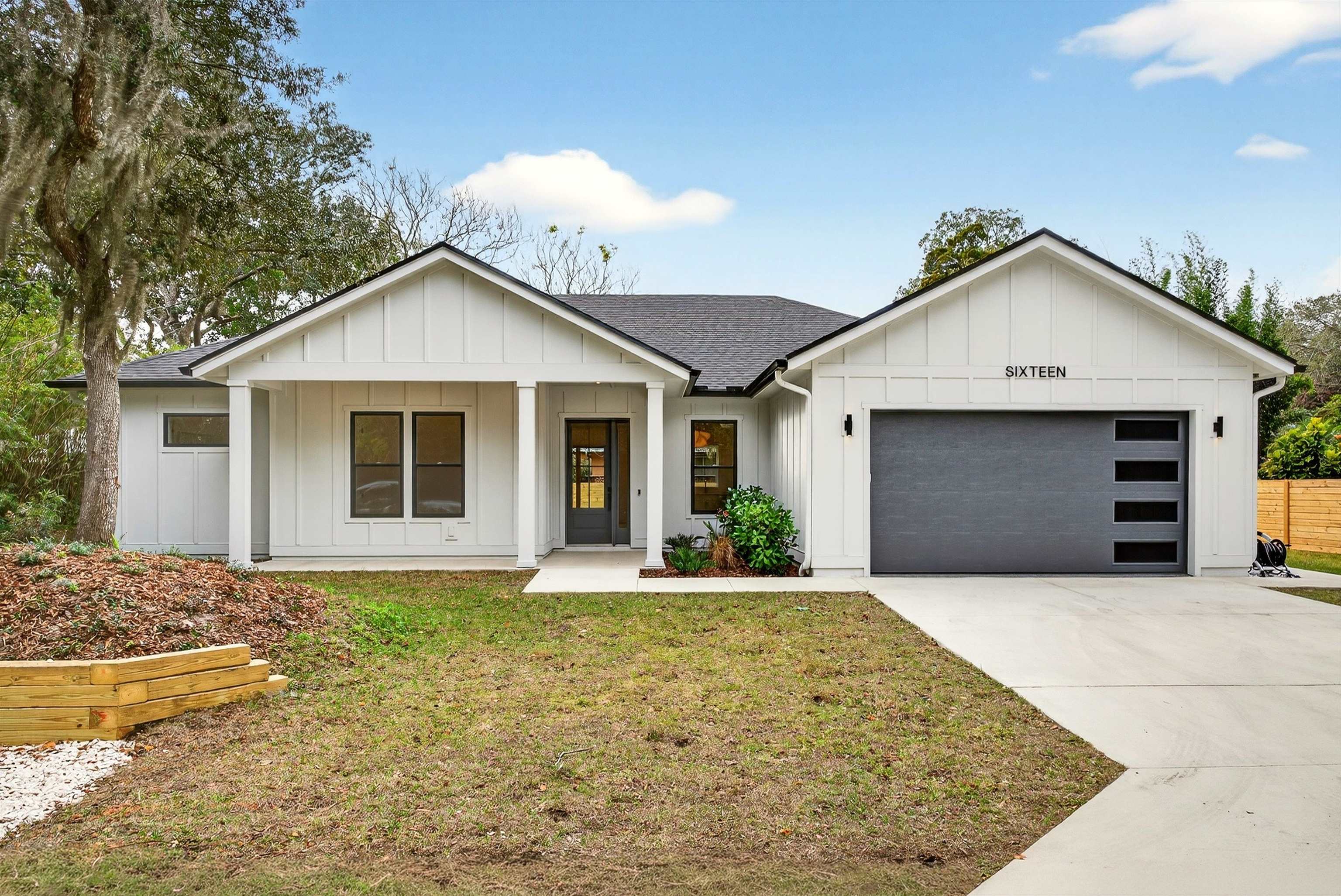 a front view of a house with yard and garage