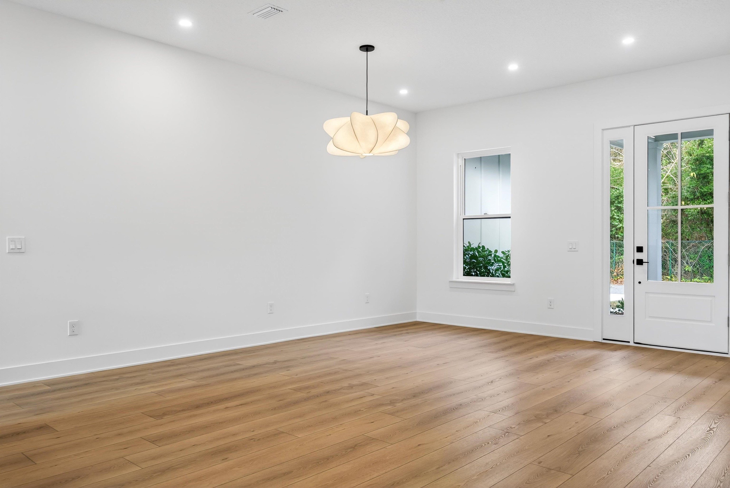 16 Baru Road St. Augustine, FL 32080 - Photo 13 of 73 an empty room with wooden floor and windows