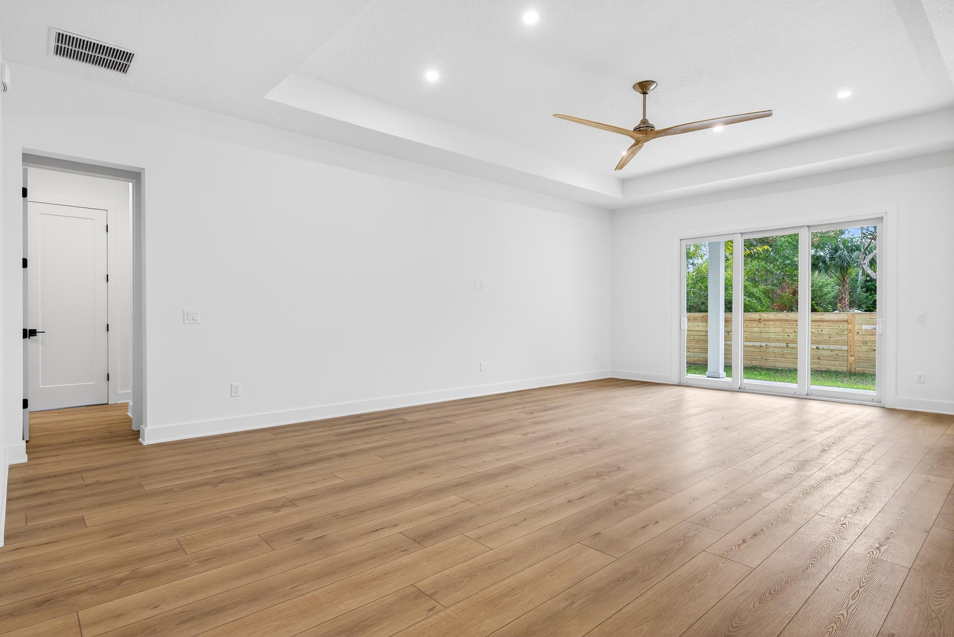 16 Baru Road St. Augustine, FL 32080 - Photo 16 of 73 a view of an empty room with wooden floor ceiling fan