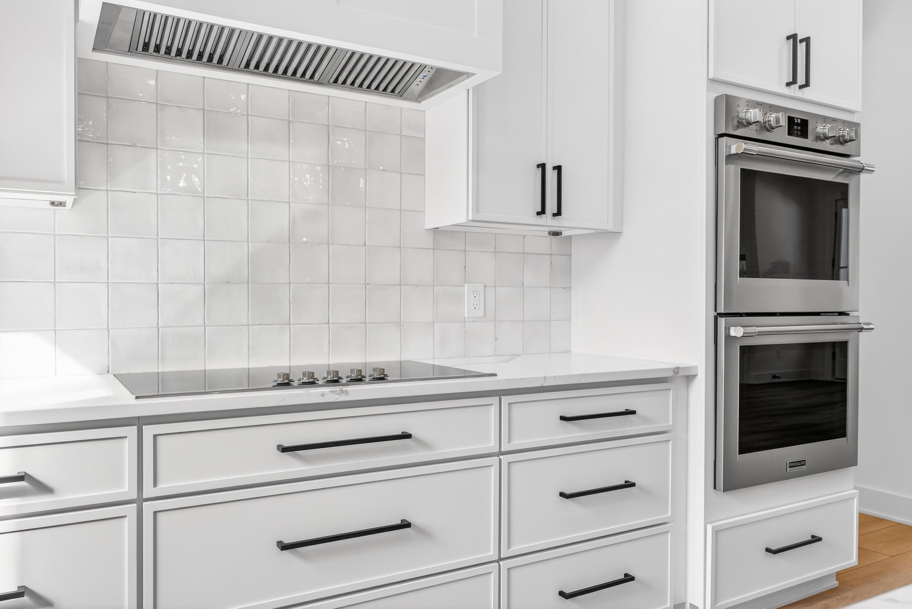 16 Baru Road St. Augustine, FL 32080 - Photo 24 of 73 a kitchen with white cabinets and white appliances