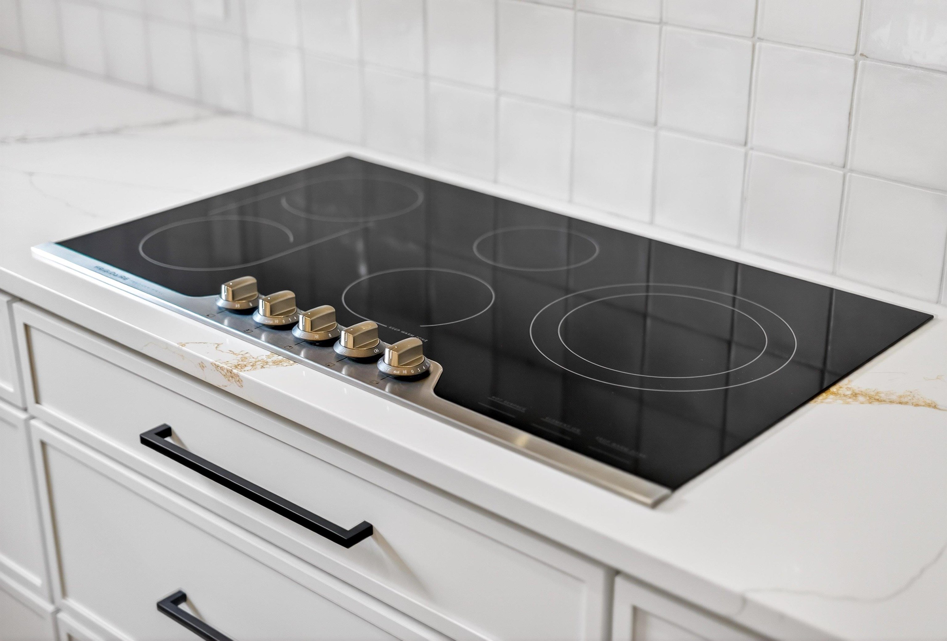 16 Baru Road St. Augustine, FL 32080 - Photo 25 of 73 a close view of a sink and a stove with white countertops