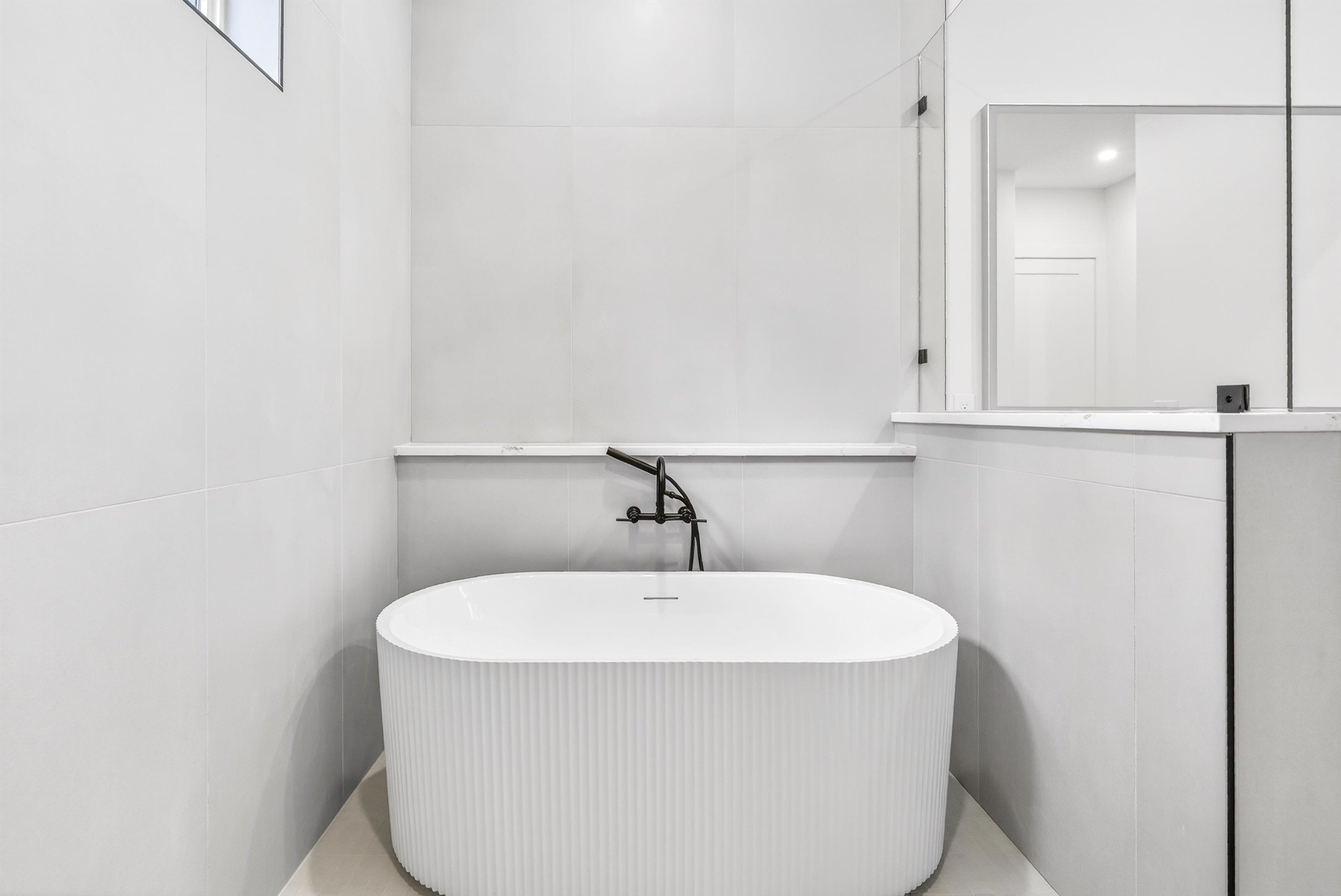 16 Baru Road St. Augustine, FL 32080 - Photo 42 of 73 Full bathroom with a freestanding bath and tile walls