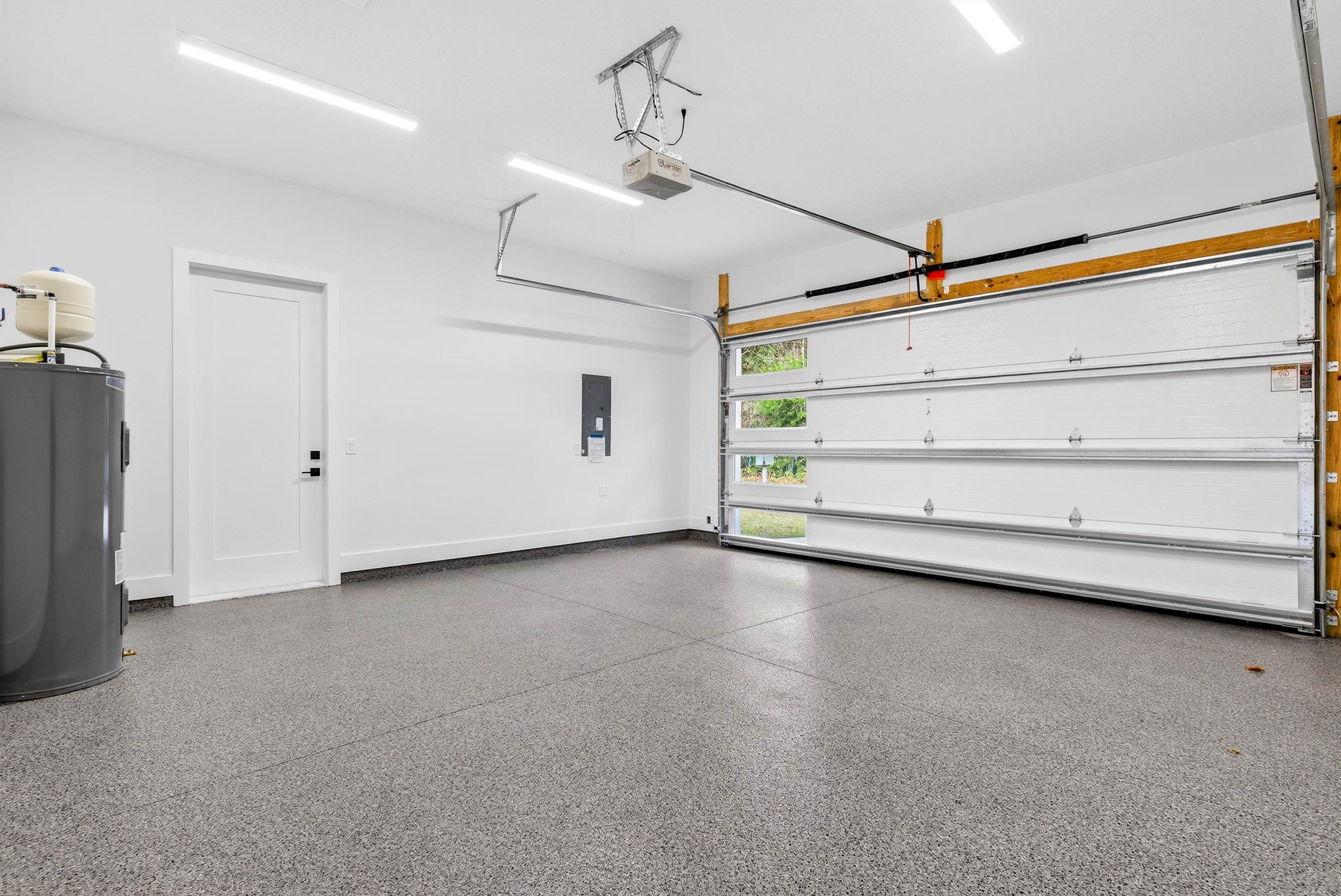 16 Baru Road St. Augustine, FL 32080 - Photo 53 of 73 Garage with water heater, electric panel, and a garage door opener