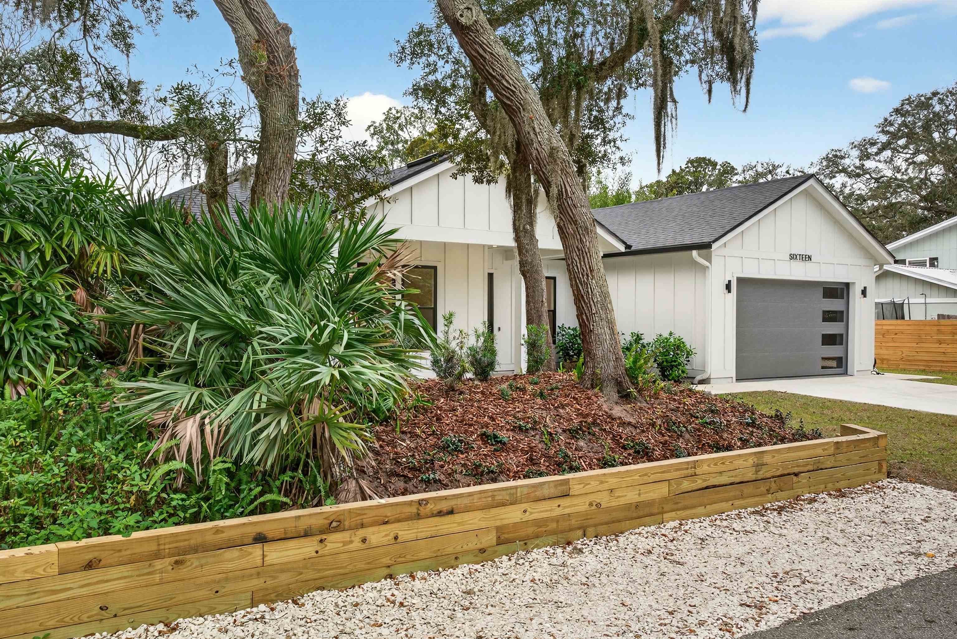 16 Baru Road St. Augustine, FL 32080 - Photo 70 of 73 View of front of house featuring board and batten siding, concrete driveway, a garage, and covered porch